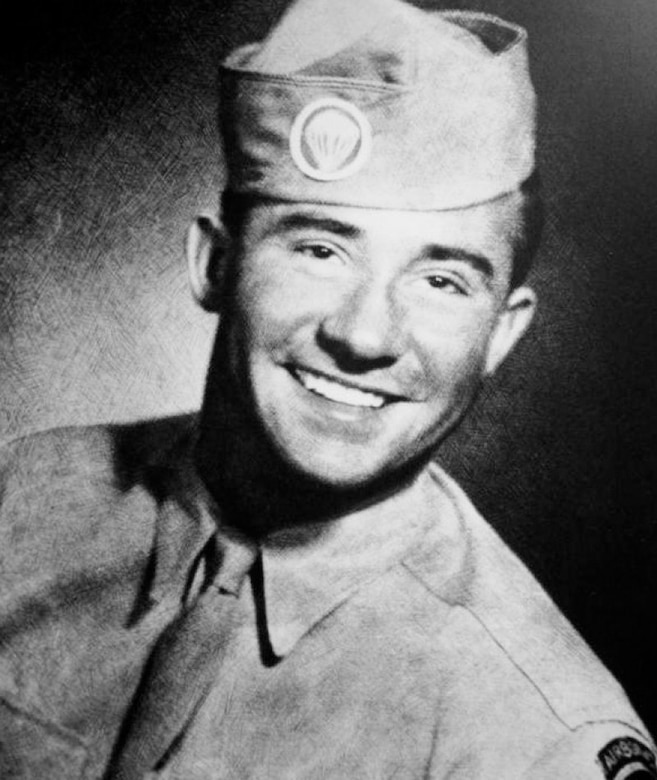 A man in a military uniform smiles for the camera.