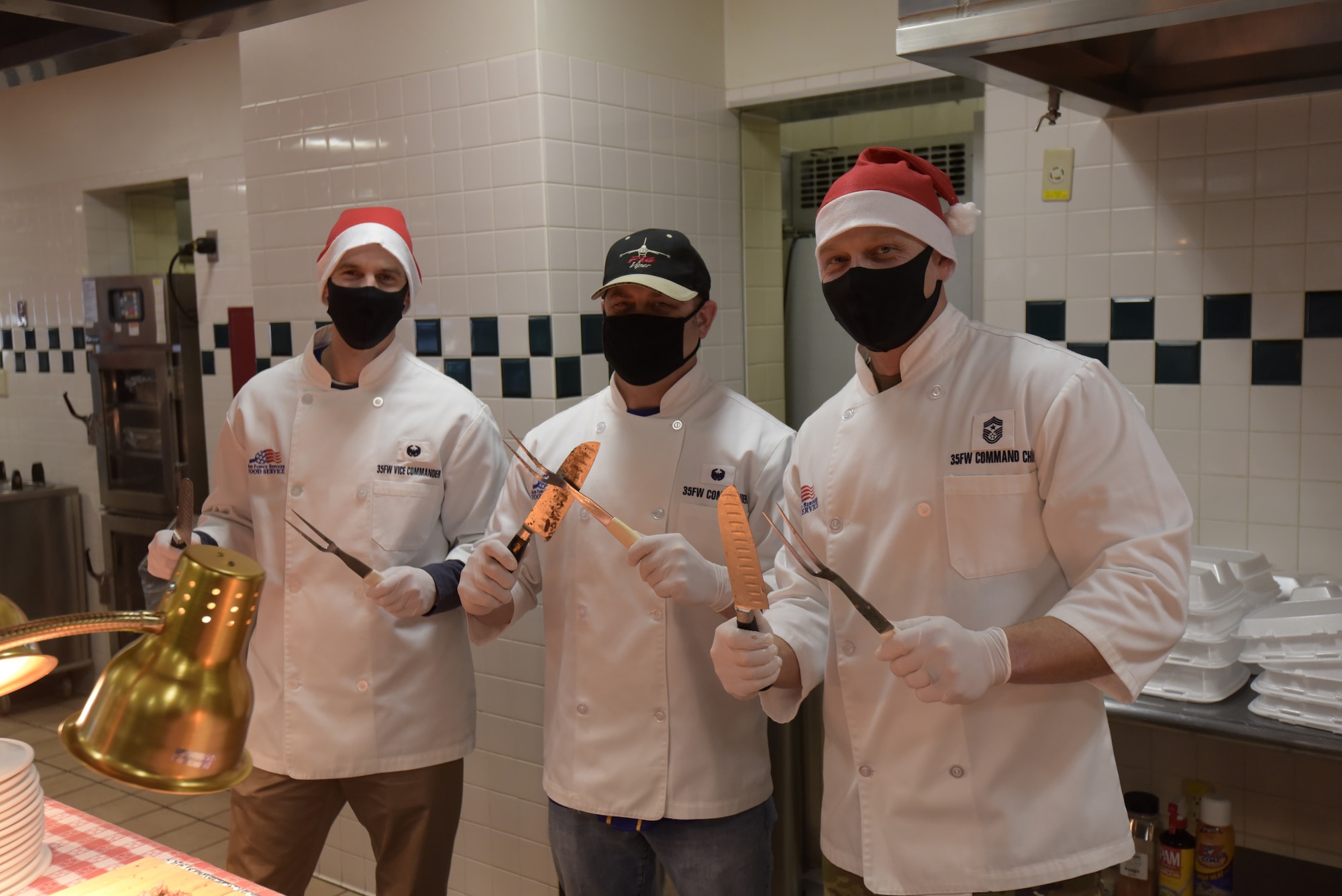 35th Fighter Wing leaders pose for a photo after serving service members a special holiday meal at the 35th Force Support Squadron Grissom Dining Facility, Misawa Air Base, Japan, Dec. 25, 2020. Wing and group leaders serve service members food during the holidays every year to thank Team Misawa for serving and support holiday camaraderie. (U.S. Air Force photo by Airman 1st Class Joao Marcus Costa)