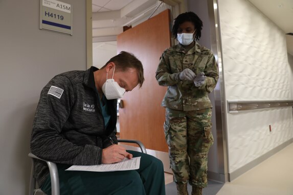 Lt. Col. Brian Cohee, a pulmonary and critical care physician assigned to the 121st Field Hospital, fills out paper work at Brian D. Allgood Army Community Hospital.