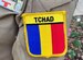The Republic of Chad flag is shown on the uniform of one of the first two women in that service to become a pilot.