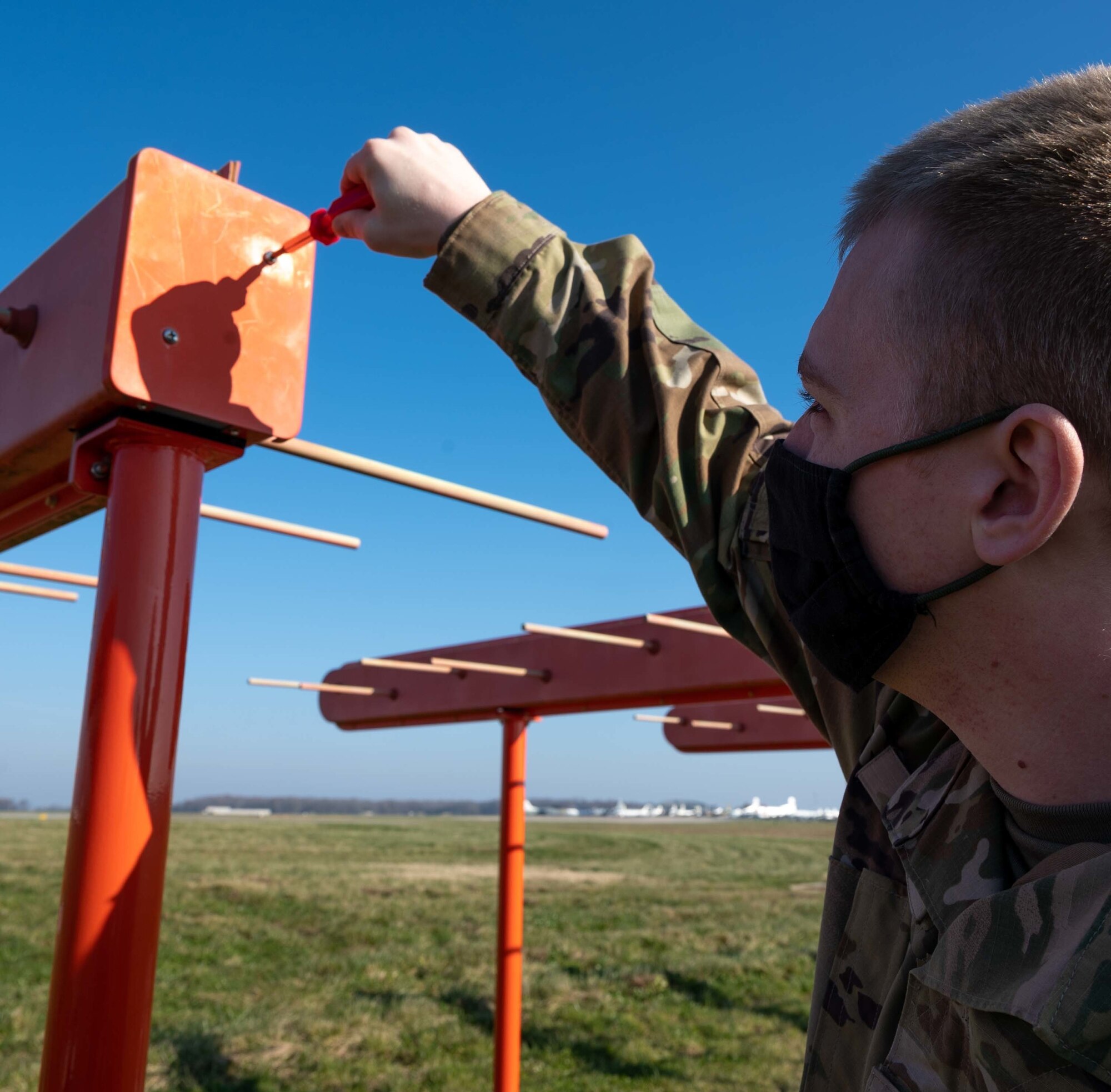 Airman 1st Class Ethan Spikes, 436th Operation Support Squadron Radar, Airfield and Weather Systems technician, makes adjustments to the Instrument Landing System, at Dover Air Force Base, Delaware, Dec. 11, 2020. The newly installed ILS is one of five of its kind in the Air Force and the only one of its kind in Air Mobility Command. Dover is serving as a test base for this new system. (U.S. Air Force photo by Airman 1st Class Faith Schaefer)