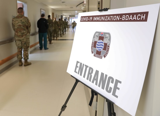 Service members stand in line to receive one of the first COVID-19 vaccines at Brian D. Allgood Army Community Hospital at U.S. Army Garrison Humphreys, South Korea Dec. 29, 2020.