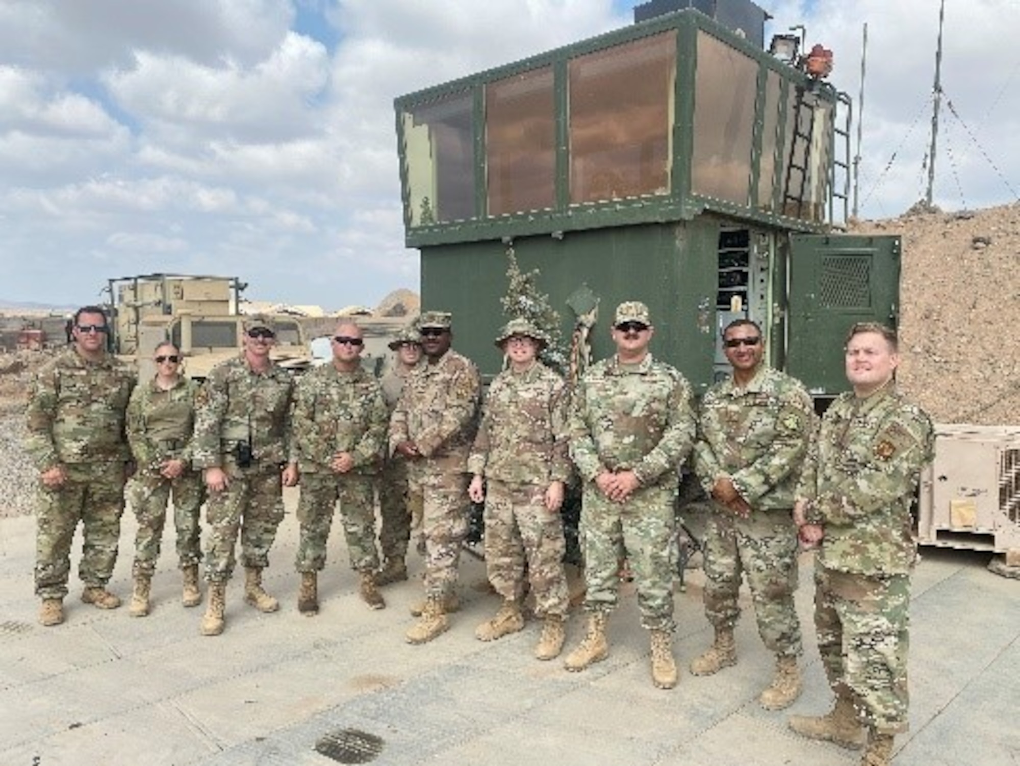 Airmen from the 776th Expeditionary Air Base Squadron Airfield Operations Flight pose for a photo Dec. 20, 2020, at Chabelley Air Base, Djibouti. The AOF is made up of four separate career fields who work together to execute Africa’s largest remotely piloted aircraft mission.