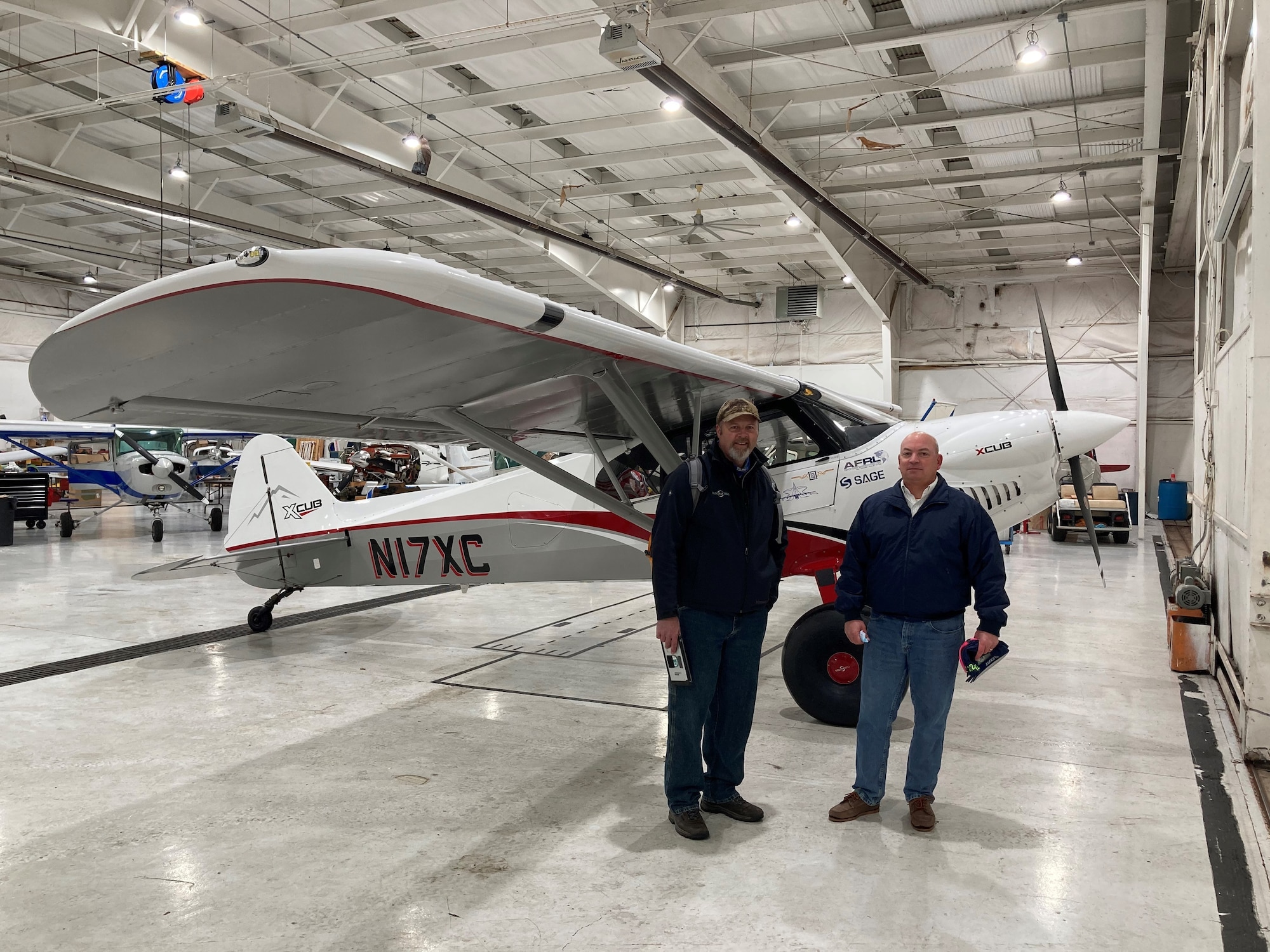CubCrafters pilot Mark Keneston (left) and Air Force Research Laboratory pilot Dr. Eric Geiselman are pictured next to AFRL LASH Lysander XCub at the Lewis A. Jackson Regional Airport in Greene County, Ohio, on Dec. 21, 2020. The aircraft made a brief stop before traveling on to the AFRL 711th Human Performance Wing’s contracted research flight test organization facility in Maryland, where it will be used to advance the initial “Lysander” personnel recovery flight experiments. (U.S. Air Force photo/Dr. Darrel G. Hopper)