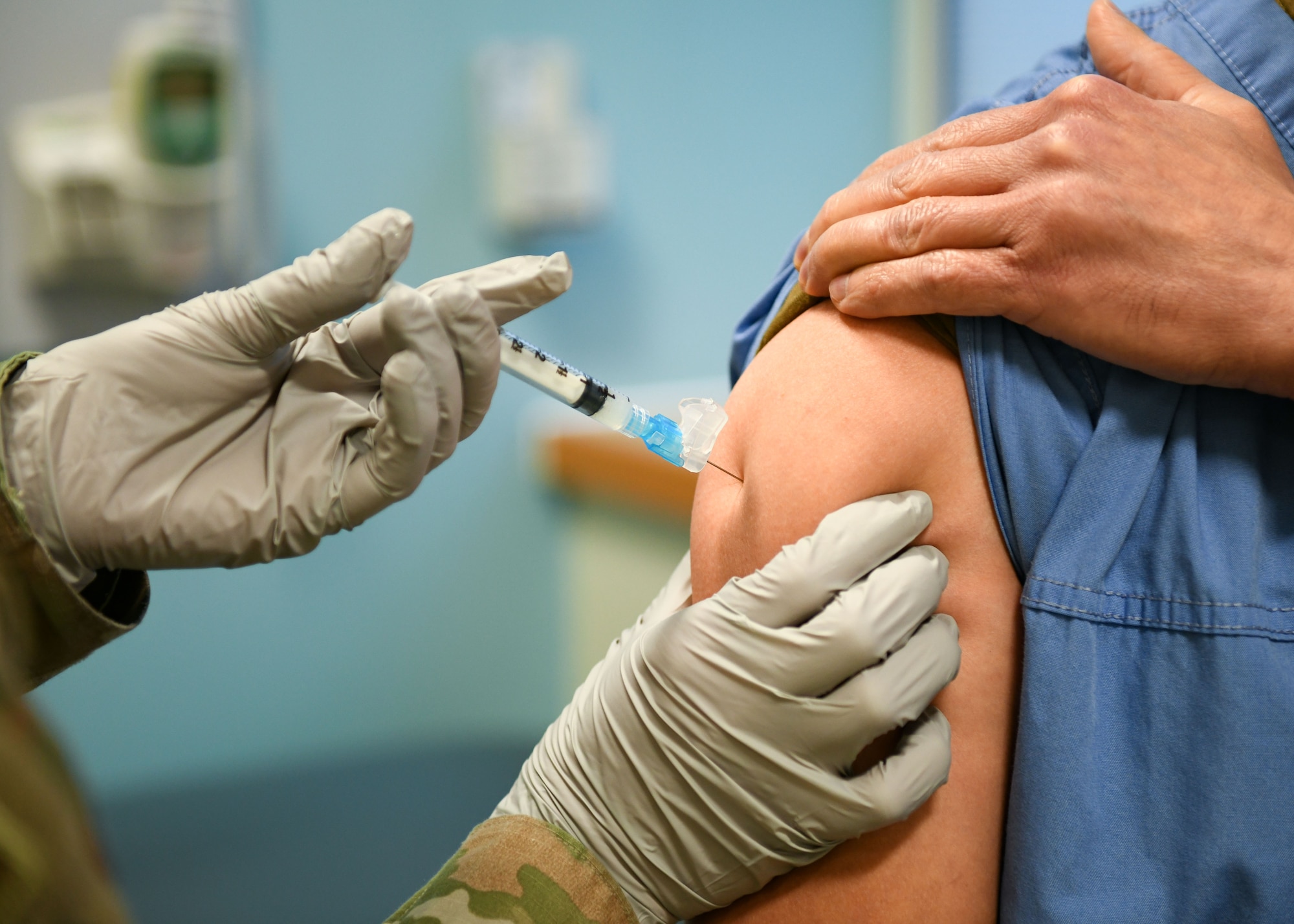 An Airman assigned to the 48th Fighter Wing Medical Group receives the COVID-19 vaccine at Royal Air Force Lakenheath, England, Dec.29, 2020. Initial vaccinations will be limited to healthcare workers and first responders to assess the process and will be used to plan an expanded distribution phase, where each service will request and administer the vaccine through a Defense Department wide phased vaccination approach. (U.S. Air Force photo by Senior Airman Madeline Herzog)