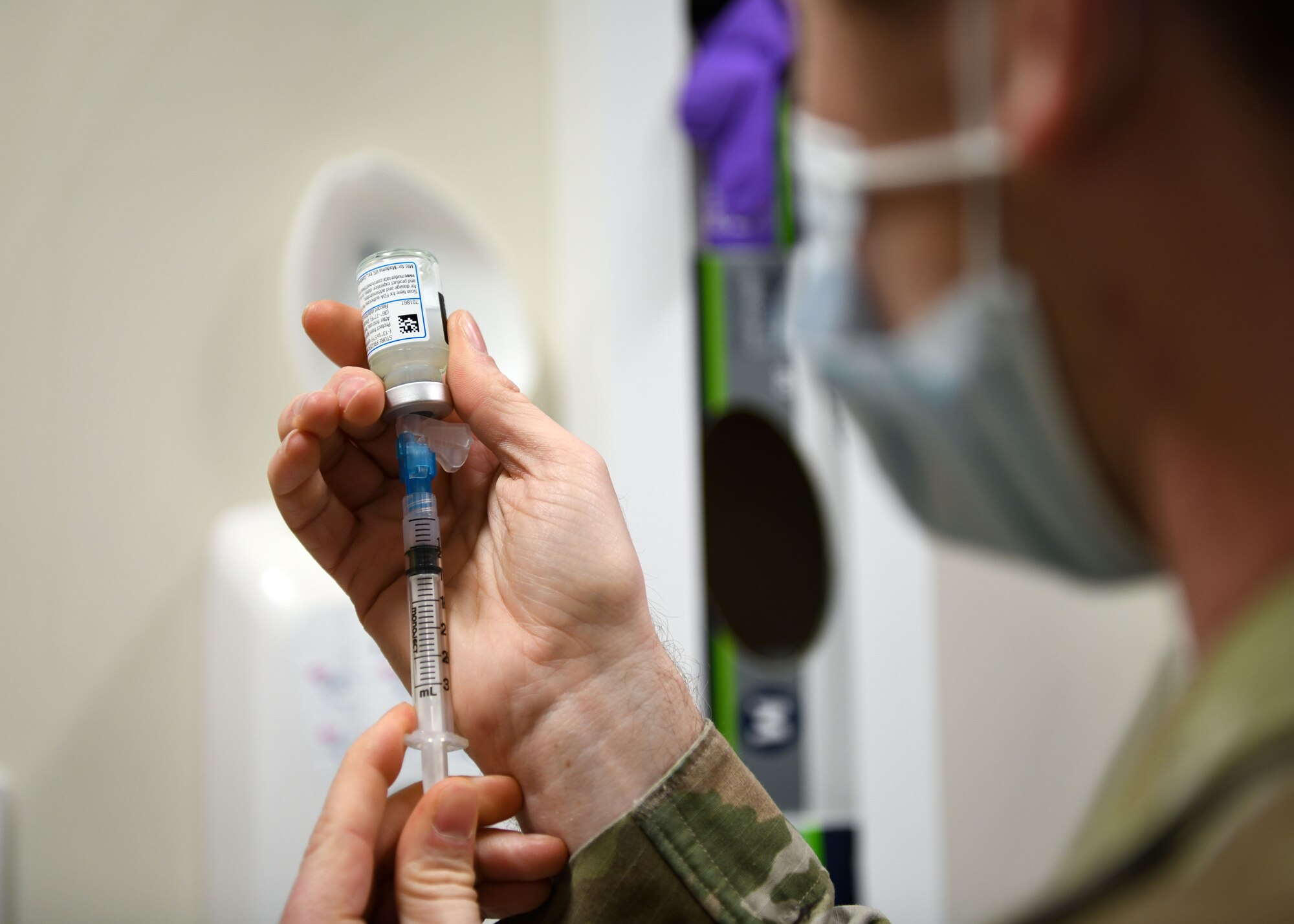 Technical Sgt. Justin Pribble, 48th Medical Group pediatrics/immunology flight chief, draws a sample of the COVID-19 vaccine at Royal Air Force Lakenheath, England, Dec. 29, 2020. Pribble was the technician responsible for administering the first COVID-19 vaccines at the 48th Fighter Wing.(U.S. Air Force photo by Senior Airman Madeline Herzog)