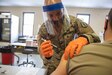 U.S. Army Staff Sgt. Nigel Chen, assigned to Joint Task Force COVID-19, New York National Guard, administers the Pfizer-BioNTech COVID-19 vaccine at the Camp Smith Training Site Medical Readiness Clinic, N.Y., on Dec. 18, 2020. The New York National Guard is participating in a Department of Defense vaccine pilot program in which 44,000 doses of the Pfizer vaccine are being administered to front line medical personnel at 16 locations around the world.