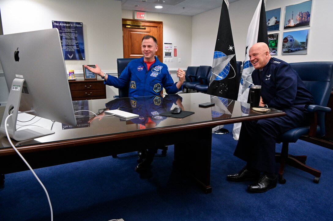 Chief of Space Operations Gen. John W. Raymond, right, and Air Force astronaut Col. Nick Hague speak with third grade students from Desoto Intermediate School in Adel, Iowa, during a virtual call at the Pentagon, Arlington, Va.