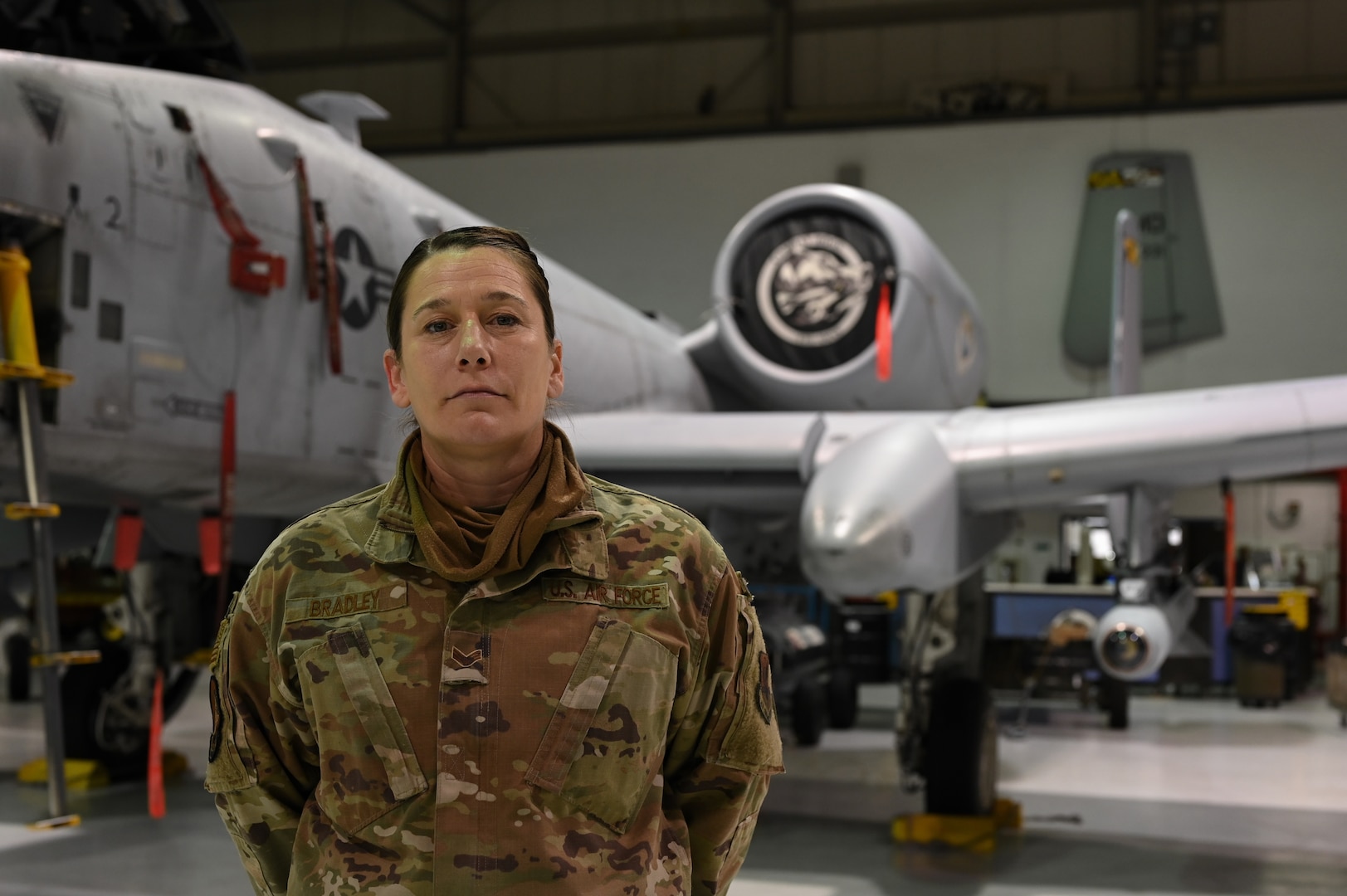 Senior Airman Jayme Bradley, an electrical and environmental specialist for the 175th Maintenance Squadron, Maryland National Guard, poses in front of an A-10C Thunderbolt II aircraft Dec. 18, 2020, at the Warfield Air National Guard Base at Martin State Airport, Middle River, Md. Bradley is the only full-time female Airman in her shop in the male-dominated career field of aircraft maintenance.