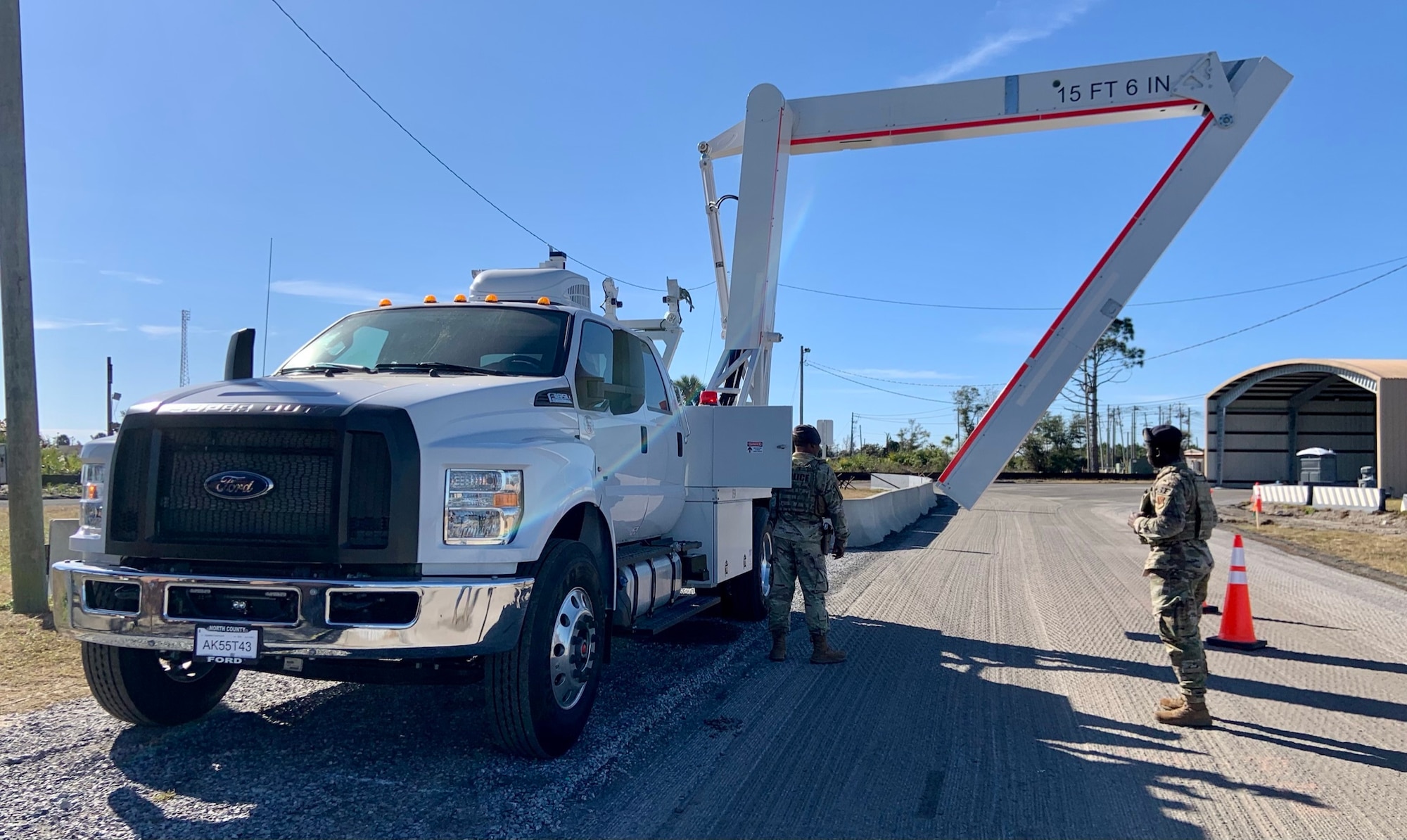 Senior Airmen Qwuantez Harris and Norman Shoemake, 325th Security Forces Squadron search specialists, deploy the Air Force’s first Mobile Vehicle Access Control Inspection System, or VACIS M6500, at the Tyndall AFB Cleveland gate.