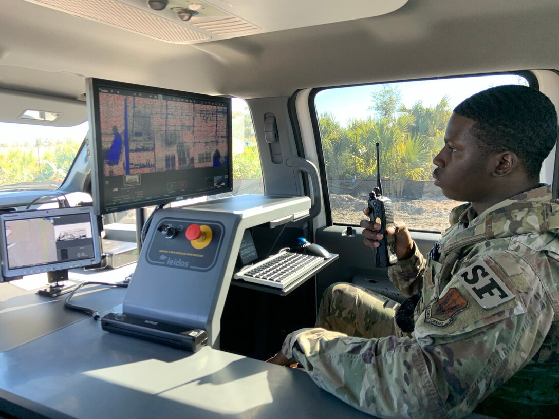 Senior Airman Norman Shoemake, 325th Security Forces Squadron search specialist, gives the all-clear to an incoming commercial vehicle after reviewing an x-ray of the vehicle and its cargo.