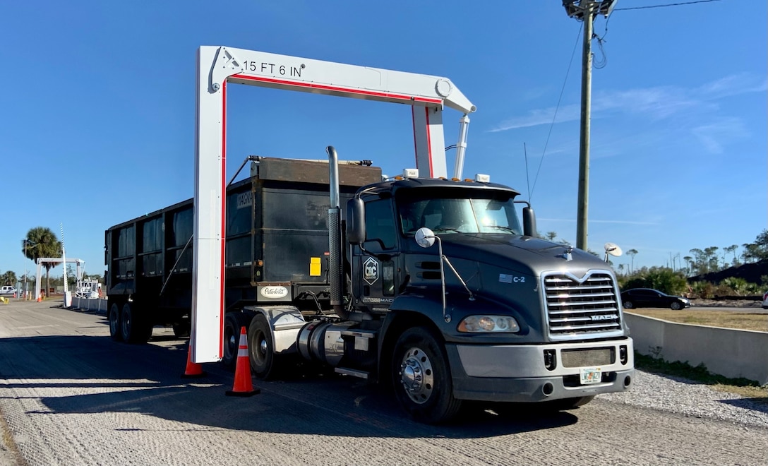 Senior Airmen Qwuantez Harris and Norman Shoemake, 325th Security Forces Squadron search specialists, deploy the Air Force’s first Mobile Vehicle Access Control Inspection System, or VACIS M6500, at the Tyndall AFB Cleveland gate.