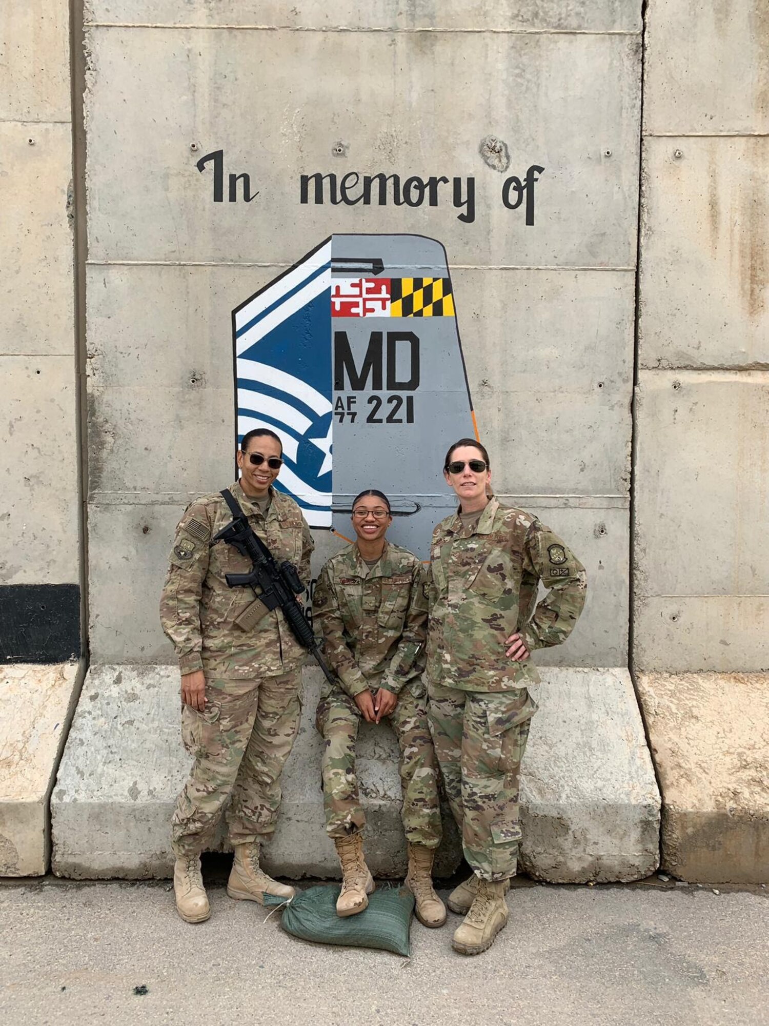 (From left) Tech. Sgt. Lindsey Bryant, Airman 1st Class Bria Bailey, and Senior Airman Jayme Bradley, Airmen assigned to the 175th Maintenance Squadron, Maryland National Guard, pose for a photo in front of a memorial April 16, 2019, during her deployment to Kandahar, Afghanistan.