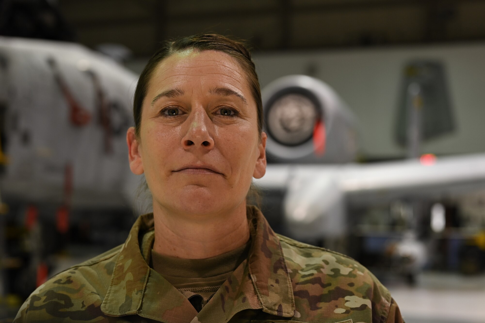 Senior Airman Jayme Bradley, an electrical and environmental specialist for the 175th Maintenance Squadron, Maryland National Guard, poses in front of an A-10C Thunderbolt II aircraft Dec. 18, 2020 at the Warfield Air National Guard Base at Martin State Airport, Middle River, Md.
