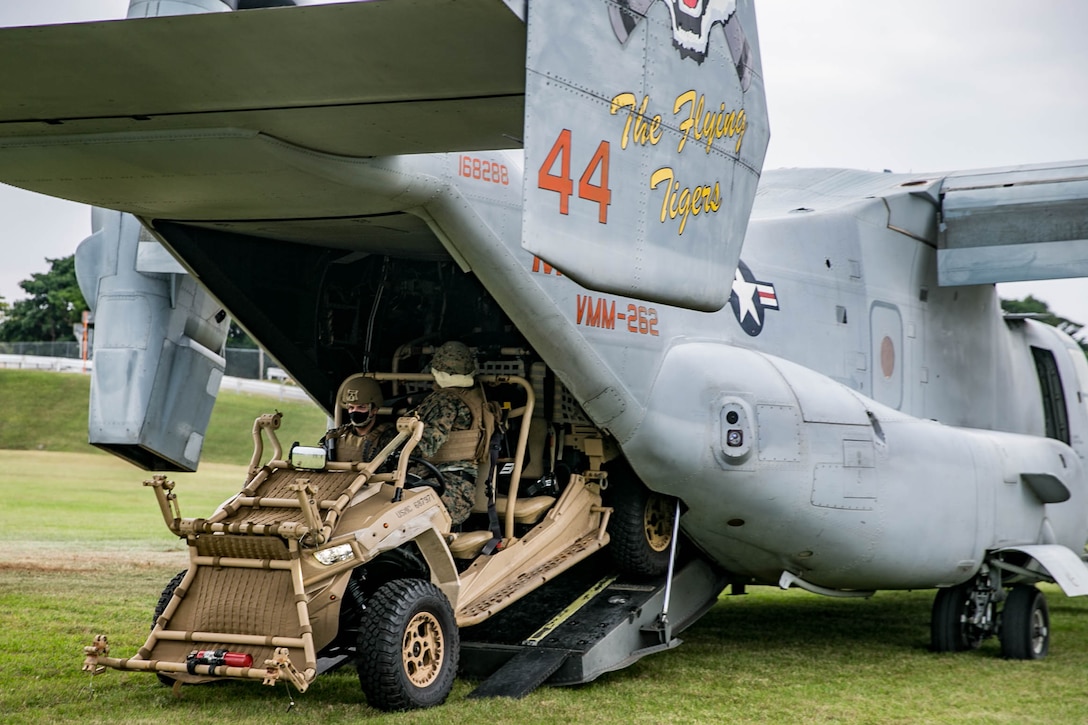 Marines with the 31st Marine Expeditionary Unit drive a Polaris MRZR light tactical all-terrain vehicles onto an MV-22B Osprey with Marine Medium Tiltrotor Squadron 262 (Reinforced), 31st MEU, at Camp Hansen, Okinawa, Japan, Dec. 8, 2020. The Marines conducted the training in order to demonstrate and enhance insertion and extraction capabilities. The 31st MEU, the Marine Corps’ only continuously forward-deployed MEU, provides a flexible and lethal force ready to perform a wide range of military operations as the premier crisis response force in the Indo-Pacific region. (U.S. Marine Corps photo by Lance Cpl. Brienna Tuck)