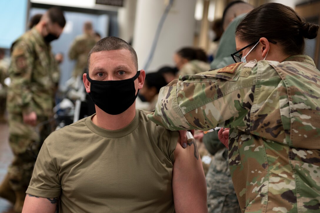 a military member receives the COVID-19 vaccine