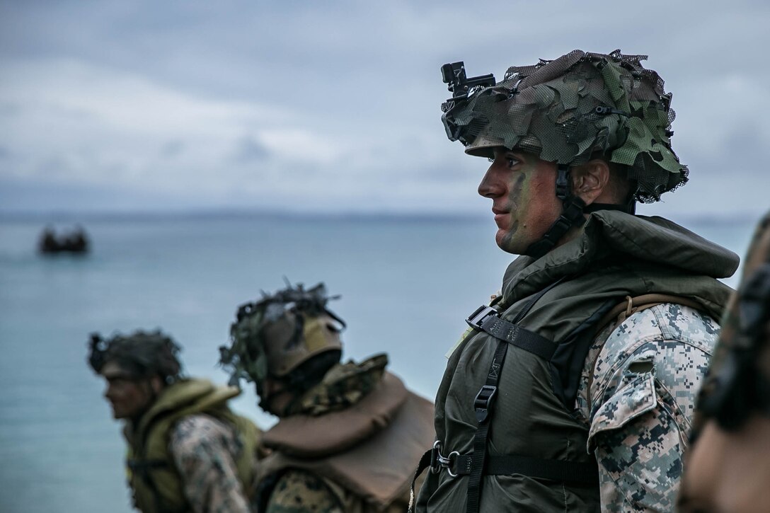 Marines with Kilo Company, BLT 3/4, 31st MEU prepare for a night boat raid during MEU Exercise at Kin Red, Okinawa, Japan, Dec. 16, 2020.