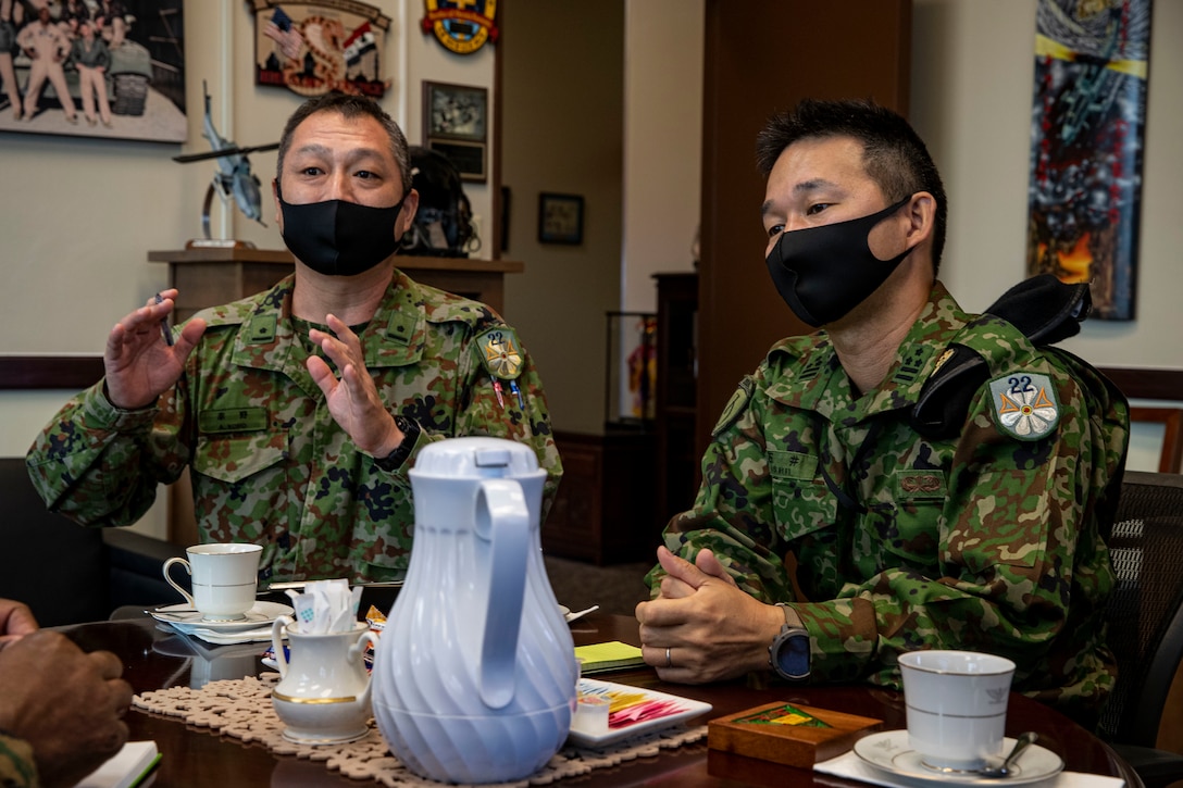 Japan Ground Self Defense Force (JGSDF), with 22nd Rapid Deployment Regiment, discuss during a tour at Marine Corps Air Station Futenma, Okinawa, Japan, Nov. 4, 2020. The tour was an opportunity for the JGSDF to conduct a site survey to familiarize themselves with MCAS Futenma’s capabilities. (U.S. Marine Corps photo by Lance Cpl. Zachary Larsen)