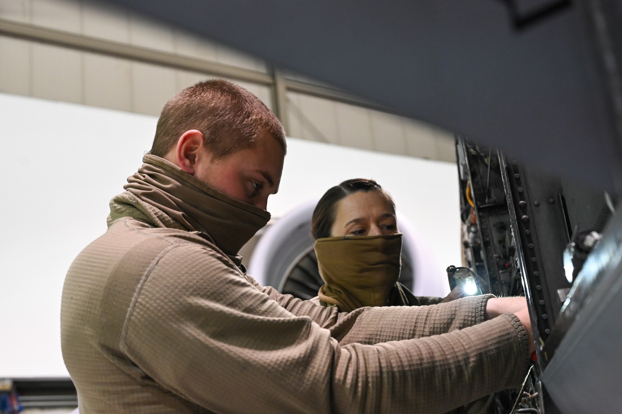 (From left) Staff Sgt. William Klingenstein and Senior Airman Jayme Bradley, both electrical and environmental specialists for the 175th Maintenance Squadron, Maryland National Guard, work on electrical components of an A-10C Thunderbolt II aircraft Dec. 23, 2020 at the Warfield Air National Guard Base at Martin State Airport, Middle River, Md.
