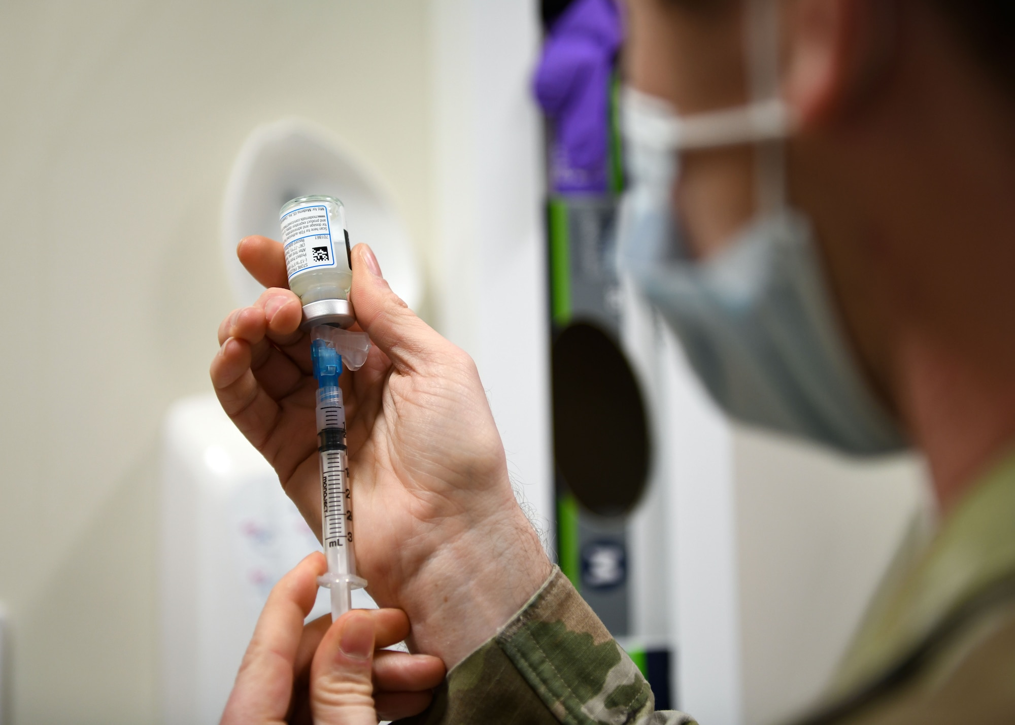 Technical Sgt. Justin Pribble, 48th Medical Group pediatrics/immunology flight chief, draws a sample of the COVID-19 vaccine at Royal Air Force Lakenheath, England, Dec. 29, 2020. Pribble was the technician responsible for administering the first COVID-19 vaccines at the 48th Fighter Wing.(U.S. Air Force photo by Senior Airman Madeline Herzog)