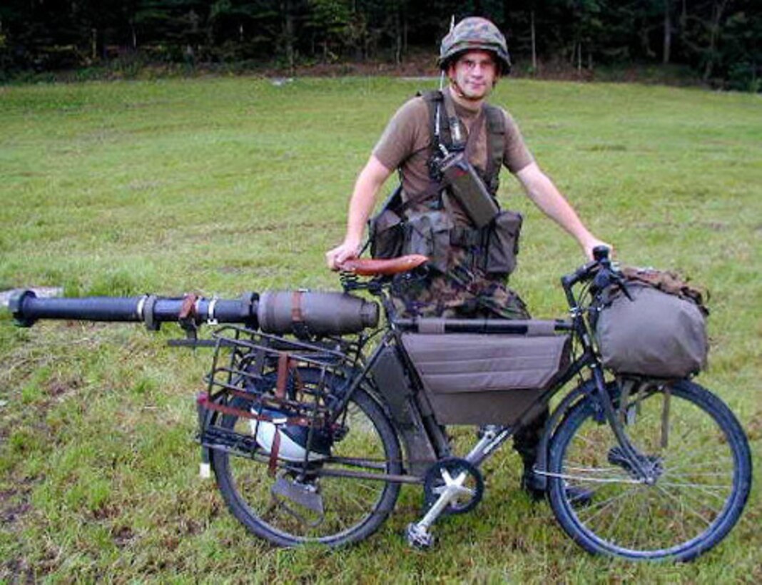 Agility and lethality. A Swiss soldier poses with his MOdell-93 bicycle, circa 1999. One could expect ROK forces would carry a similar load in the mountain trails of the ROK.