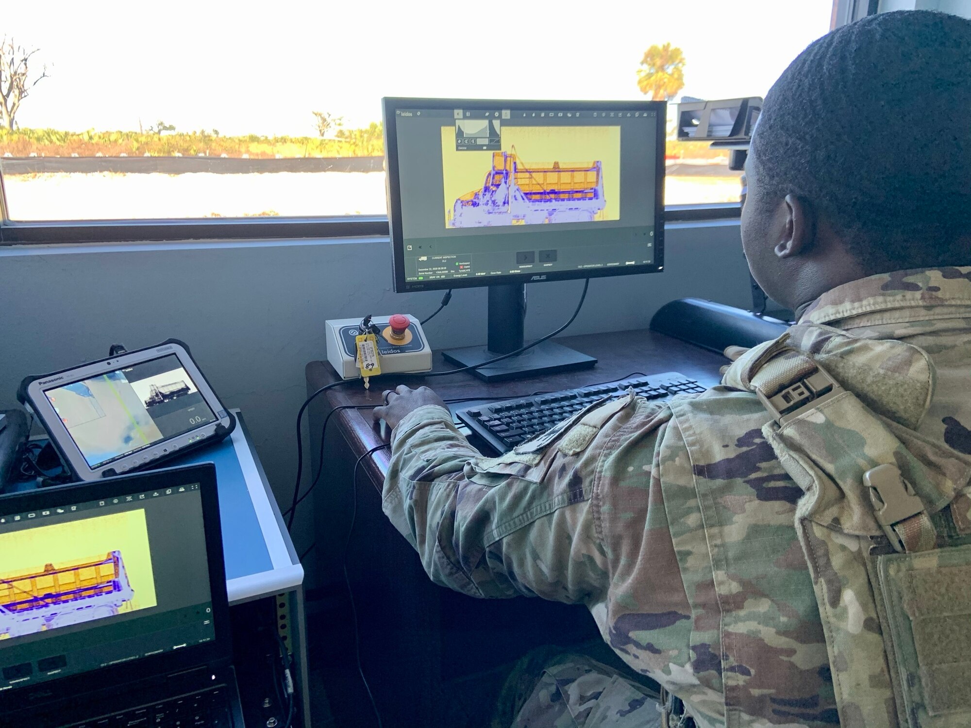 Senior Airman Norman Shoemake, 325th Security Forces Squadron search specialist, reviews x-ray images of commercial vehicles seeking access to Tyndall AFB.