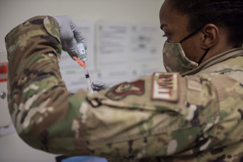 a photo of a woman preparing a medical syringe