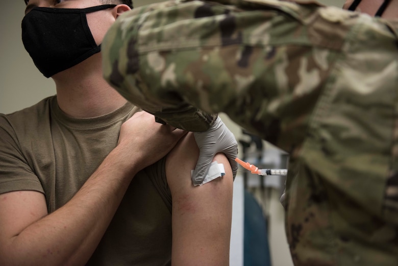 a photo of a man getting a vaccine shot