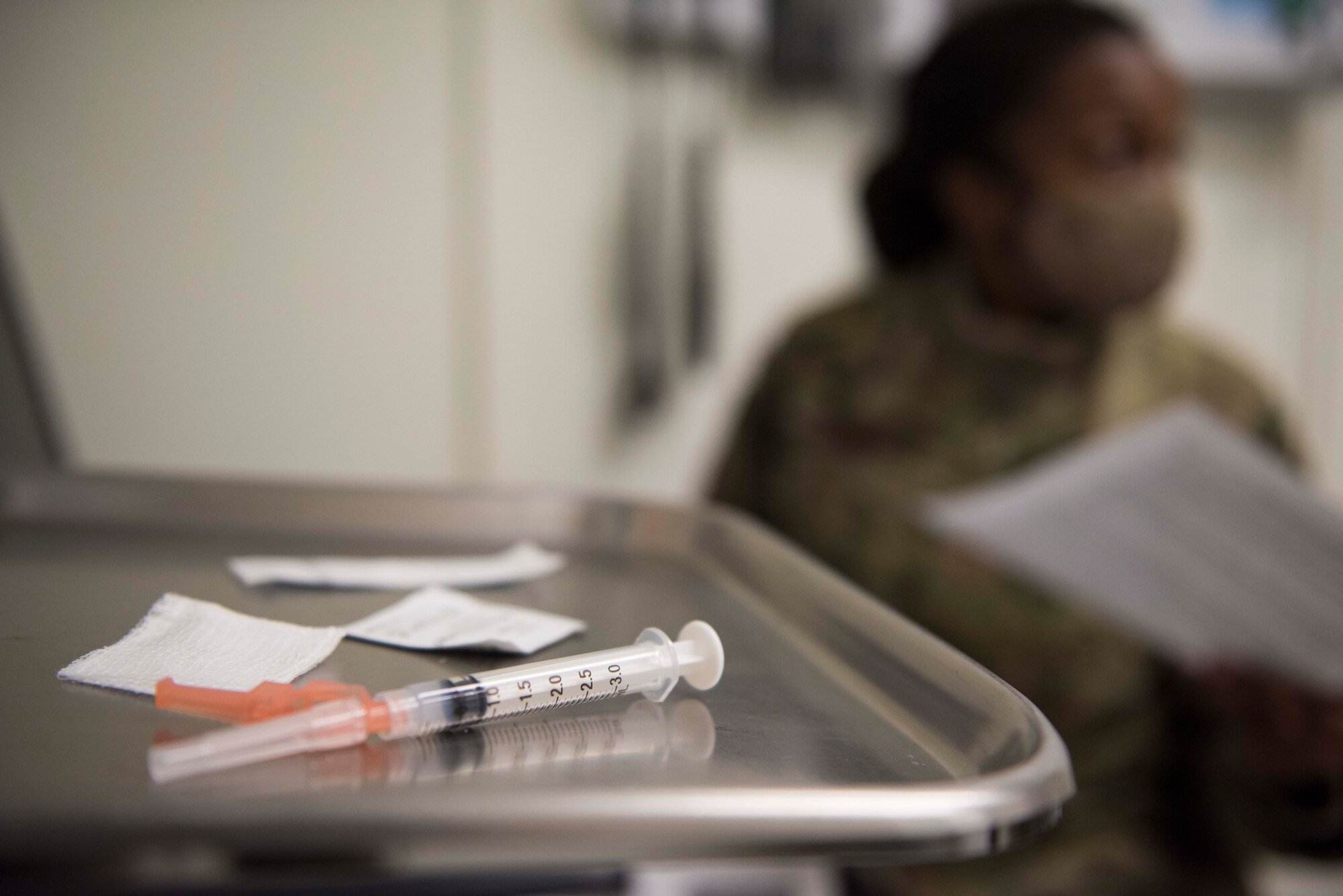 a photo of a syringe sitting on a medical tray