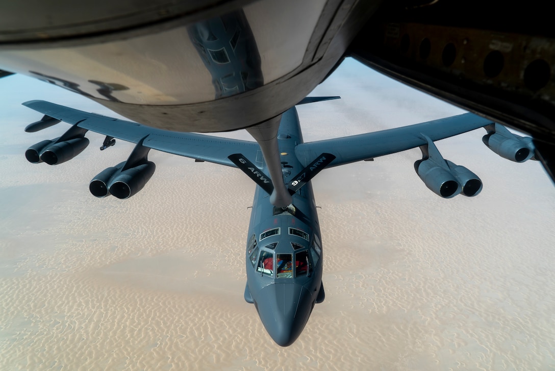 A U.S. Air Force B-52 from Minot Air Force Base is aerial refueled by a KC-135 Stratotanker over the U.S. Central Command area of responsibility Dec. 30, 2020. The B-52 Stratofortress is a long-range, heavy bomber that is capable of flying at high subsonic speeds at altitudes of up to 50,000 feet and can carry nuclear or precision guided conventional ordnance with global reach precision navigation capability. (U.S. Air Force photo by Senior Airman Roslyn Ward)