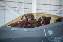 An F-35A Lightning II Joint Strike Fighter pilot assigned to the 158th Fighter Wing, Vermont Air National Guard, adjusts a POW/MIA flag while preparing for takeoff from Vermont Air National Guard Base May 22. Four F-35As honored Vermont’s front line COVID-19 responders and essential workers with a 90-minute statewide flyover as part of Operation America Strong, an Air Force effort to salute healthcare workers across the country.