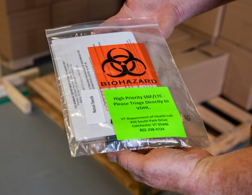 Air Force Master Sgt. Karl Johansen holds a COVID-19 test kit at the Strategic National Stockpile Warehouse, Aug. 27, 2020. Airmen from across the Vermont Air National Guard's 158th Fighter Wing have supported operations at the SNS Warehouse since March 2020, and continue to support Vermont's efforts to distribute personal protective equipment throughout the state and conduct widespread testing for COVID-19. Johansen is a test kit assembly team supervisor with the 158th FW.