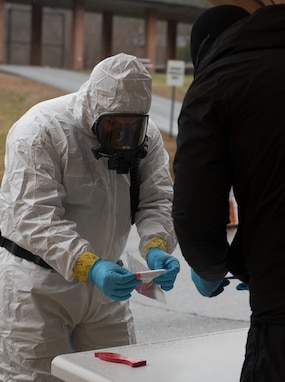 Sgt. 1st. Class Mason Lord verifies a sample for collection at a COVID-19 sample site at the Landmark College campus in Putney, Vt., April 3, 2020. The Vermont National Guard is working with the state of Vermont and emergency response partners in a whole-of-government effort to flatten the curve during the COVID-19 pandemic. Lord is a survey team chief with the Vermont National Guard's 15th Civil Support Team.