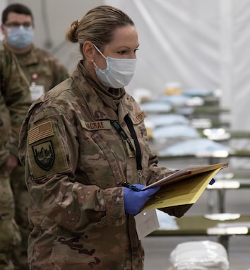 Air Force Maj. Amber Macrae practices going over patient information at the Alternate Healthcare Facility in Essex, Vermont, April 7, 2020. The Vermont National Guard is working with the state of Vermont and emergency response partners in a whole-of-government effort to flatten the curve of the COVID-19 pandemic. Macrae is a medical provider with the 158th Medical Group.