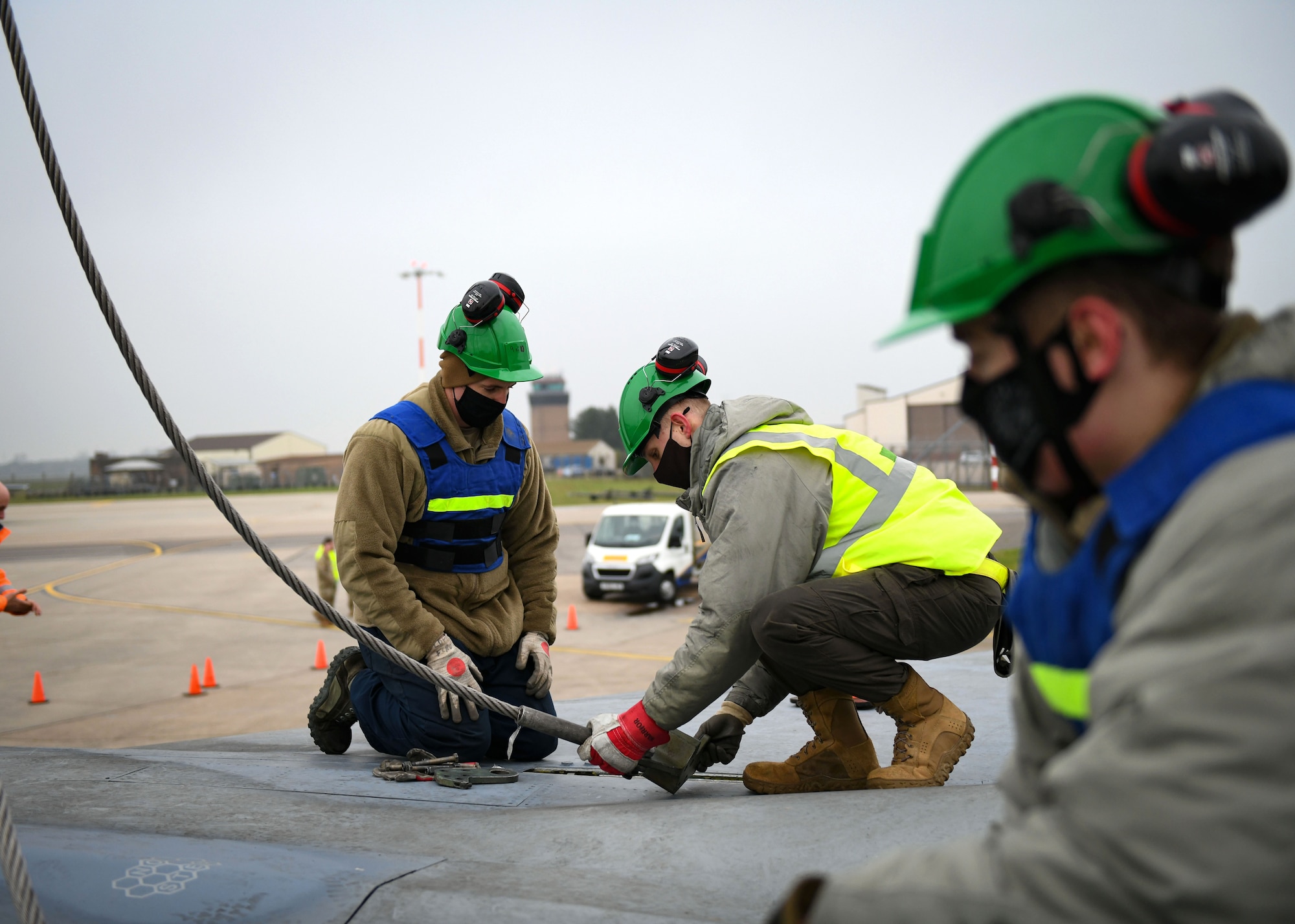 Airmen assigned to the 48th Equipment Maintenance Squadron repair and reclamation sections attach an aircraft sling as part of the Crash Damaged Disabled Aircraft Recovery program during a simulated aircraft lift at Royal Air Force Lakenheath, England, Dec. 29, 2020. The CDDAR program ensures members are ready and postured to provide the Liberty Wing with emergency crash and recovery capabilities if necessary.  (U.S. Air Force photo by Senior Airman Madeline Herzog)