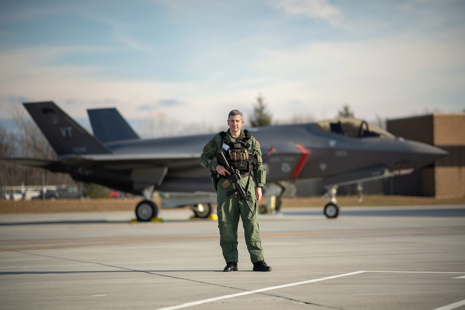 James Sides stands for a portrait in front of an F-35A Lightning II Joint Strike Fighter at the Vermont Air National Guard base, South Burlington, Vermont, Dec 3, 2020. Sides was recently named Air National Guard security forces flight level civilian supervisor of the year for 2020. Sides is a security operations supervisor with the 158th Security Forces Squadron.