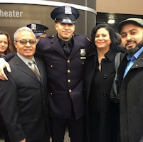 Staff Sgt. Samuel Garcia, intelligence analyst noncommissioned officer, 719th Movement Control Battalion, poses for a photo with his father and mother Adalberto and Maria Garcia, along with his brother Ronny Garcia at his New York City Police Academy graduation.