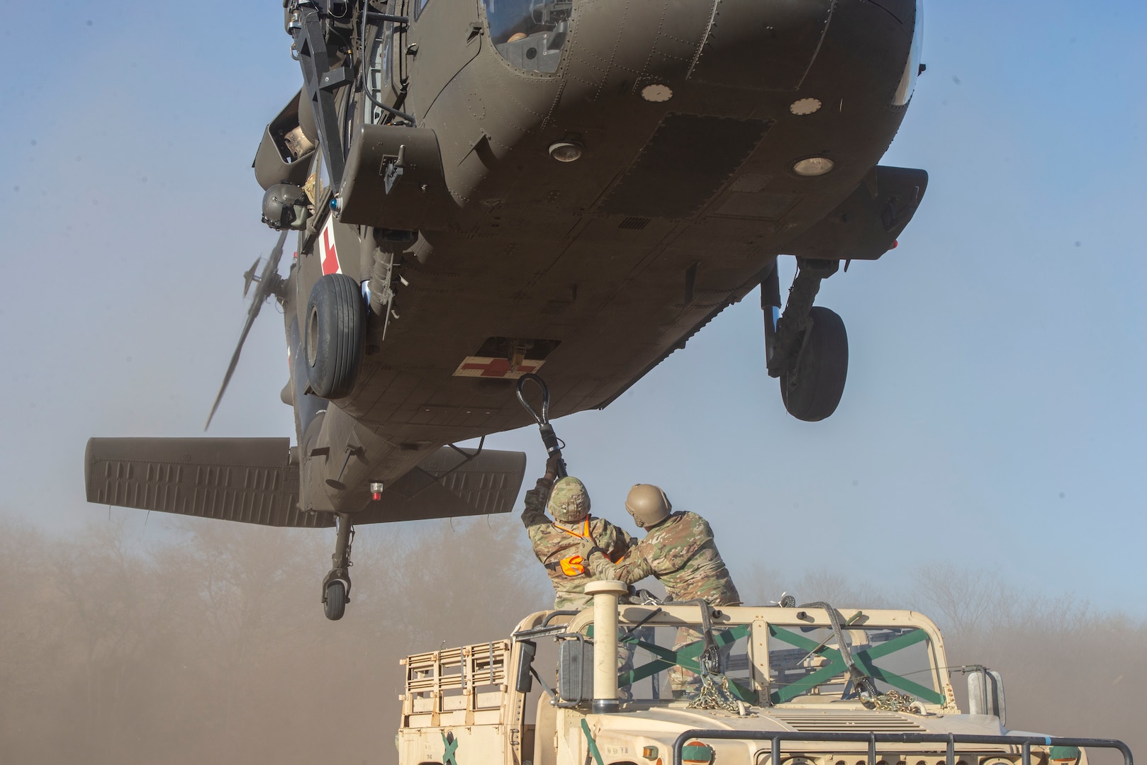 U.S. Air Force Reserve Component Airmen assigned to the 74th Aerial Port Squadron, Texas Army National Guard Soldiers from the 2nd Company, 149st Aviation Regiment and 108th Aviation Regiment, and active-duty members from the Air Force Special Warfare Training Support Squadron participate in a helicopter rigging mission, Dec. 15, 2020, at Joint Base San Antonio-Chapman Annex, Texas.