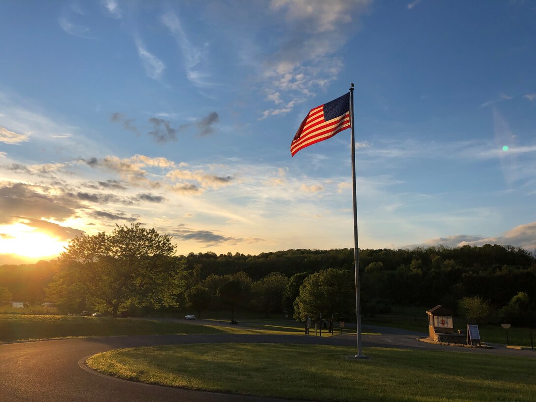Photo shows an American flag flapping in the wind at a boat launch at Blue Marsh Lake.