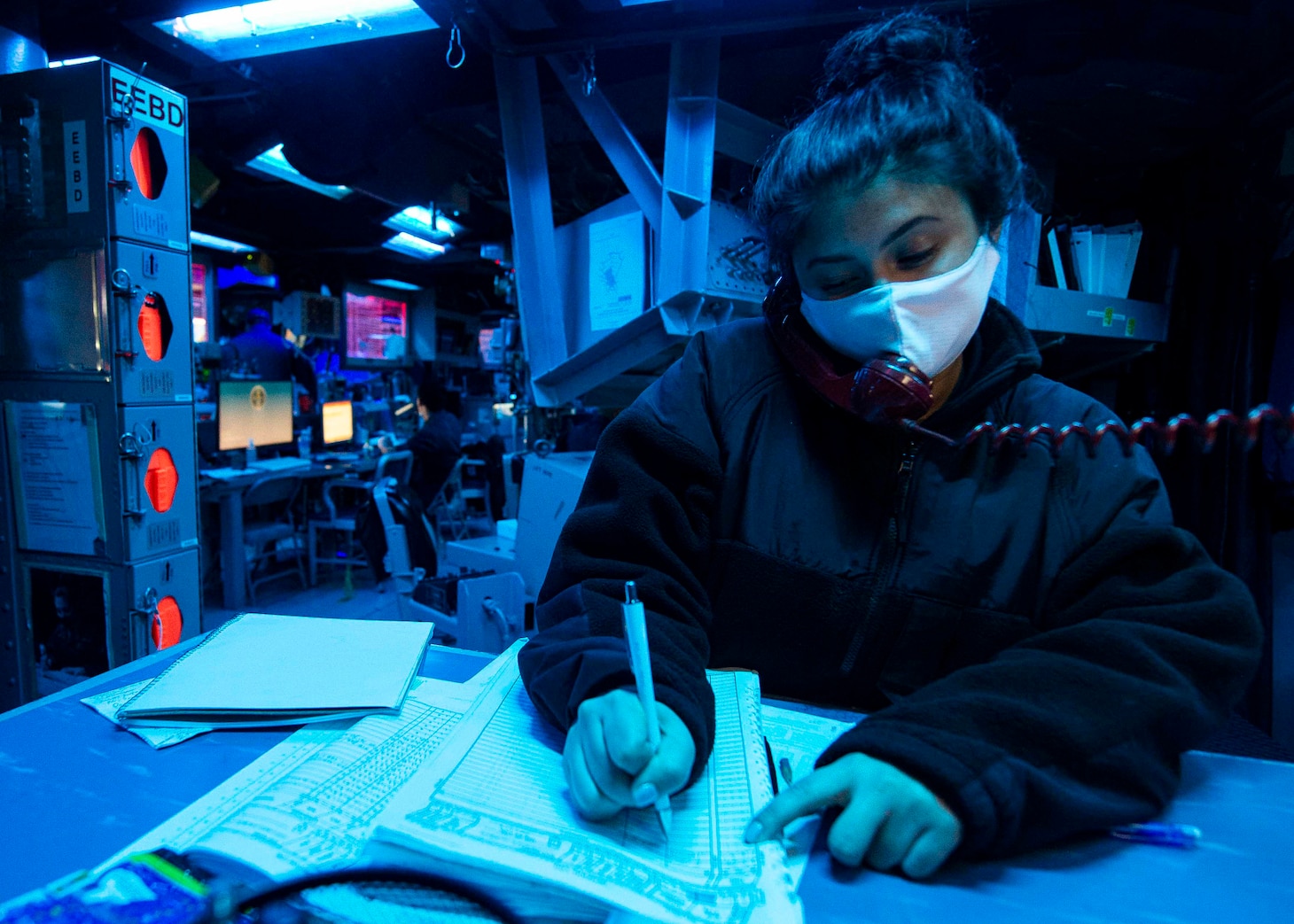 TAIWAN STRAIT (Dec. 30, 2020) Operations Specialist Seaman Jennifer Diaz, from Brooklyn, NewYork, writes in a deck log in the combat information center as guided-missile destroyer USS Curtis Wilbur (DDG 54) conducts routine operations. Curtis Wilbur is forward-deployed to the U.S. 7th Fleet area of operations in support of a free and open Indo-Pacific.