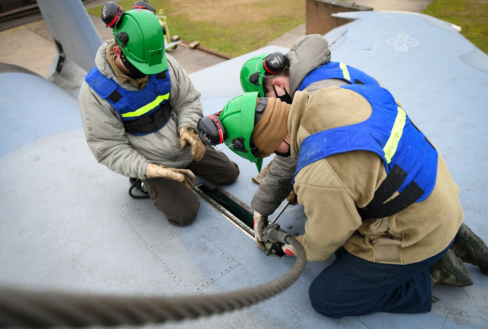 Airmen assigned to the 48th Equipment Maintenance Squadron repair and reclamation sections attach an aircraft sling to an F-15B during a simulated crash and recovery lift training at Royal Air Force Lakenheath, England, Dec. 29, 2020. The training enabled six team chiefs and eight Crash Damaged Disabled Aircraft Recovery program members to attain recertification so they can be ready at a moment’s notice if called upon. (U.S. Air Force photo by Senior Airman Madeline Herzog)