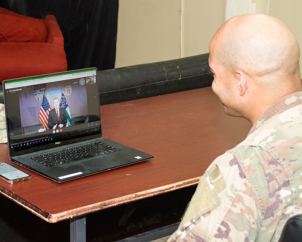 New York Police Officer and U.S. Army Staff Sgt. Samuel Garcia, intelligence analyst noncommissioned officer, 719th Movement Control Battalion, receives a special holiday call from New York City Police Commissioner Dermot Shea at Camp Arifjan, Kuwait, Dec. 23, 2020. During the call Shea thanked Garcia for his continued service to the nation as he serves his country in support of Operation Spartan Shield.