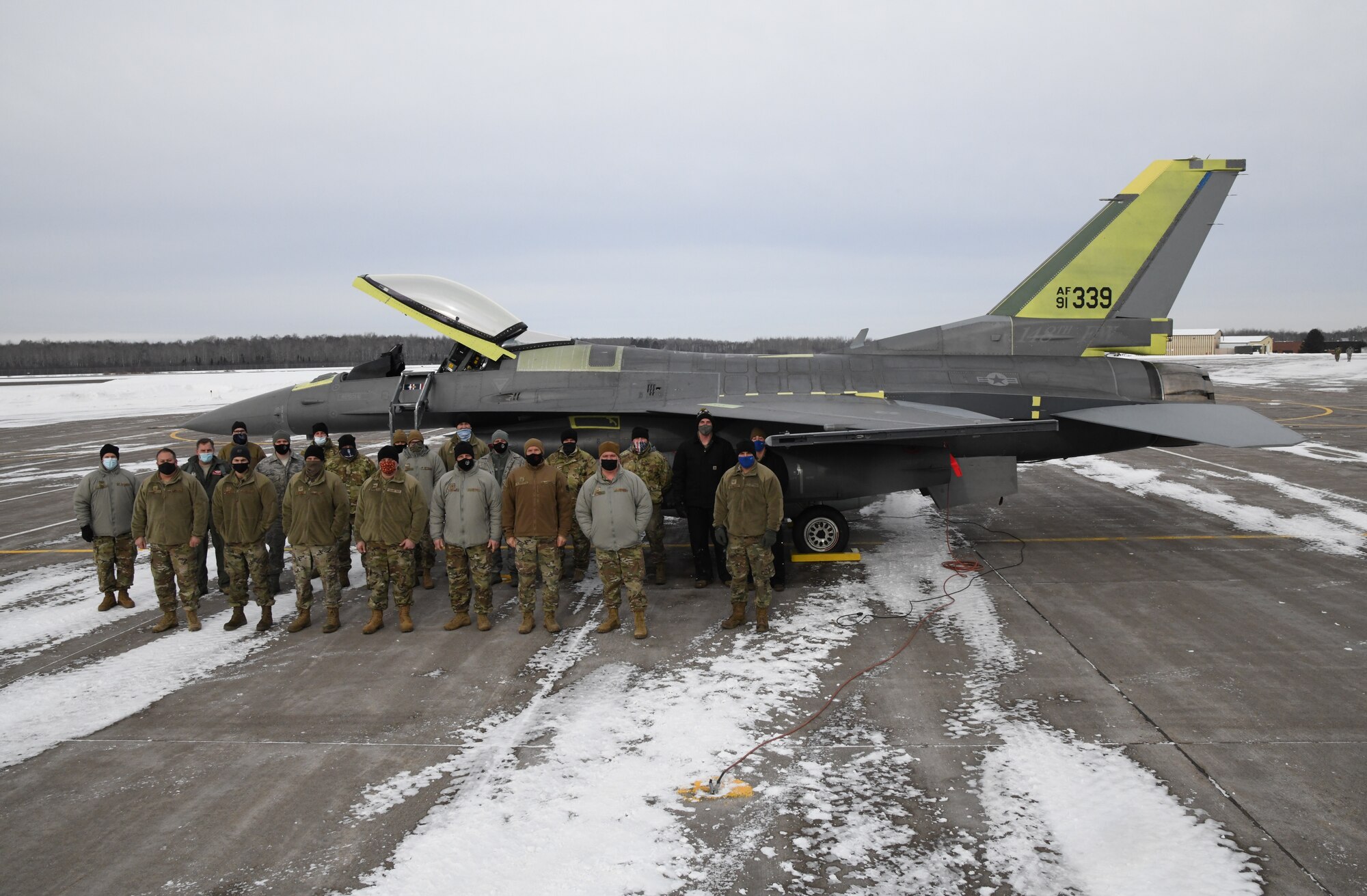 148th Maintenance Group personnel and Lt. Col. R. Matt Russell, Chief of F-16 Flight Tests and pilot for the F-16 System Program Office at Hill Air Force Base pose for a photo when aircraft 339, an F-16 that was severely battle damaged in 2018, was returned to the 148th Fighter Wing.