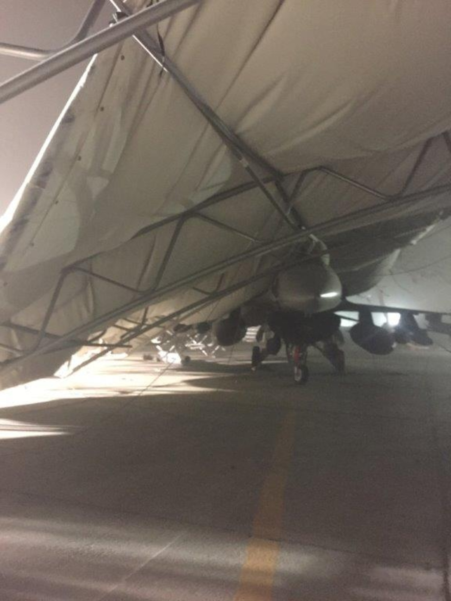 An aircraft sunshade collapsed onto an F-16 Fight Falcon due to a storm with 91-mile per hour winds at the 407th Air Expeditionary Group in 2018. (U.S. Air National Guard photo by MSgt Tom Krob)