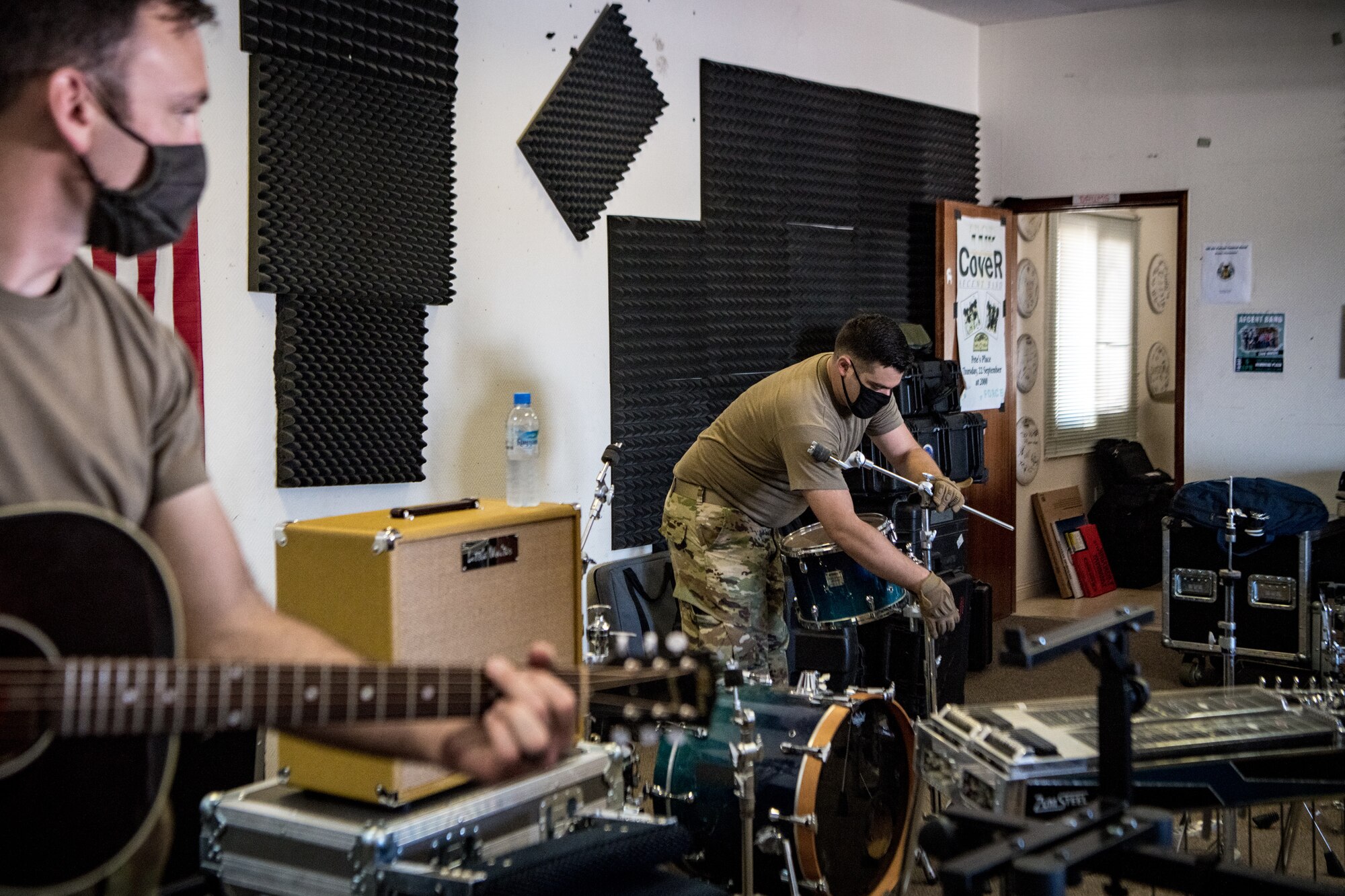 man sets up drum kit