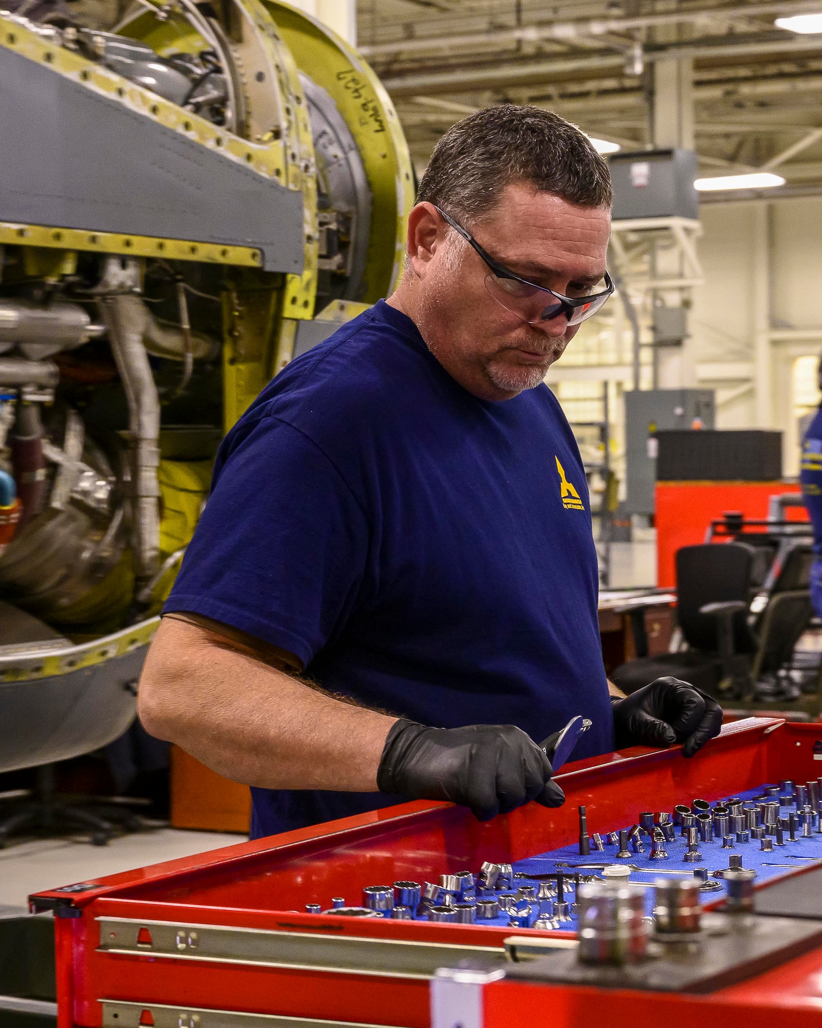 Tom Schilling, a Contract Field Team member, gathers the proper tools to complete the assembly of a refurbished engine, Dec. 29, 2020, at Little Rock Air Force Base, Ark. The facility produces all C-130H Hercules T-56 3.5 modified engine and 54H60-117 propeller overhauls for Air Force Reserve Command and various Air National Guard units. The average overhaul cost for a T-56 engine here is approximately $800,000 as compared to $1.5 million per engine from the commercial repair facility. (U.S. Air Force Reserve photo by Maj. Ashley Walker)