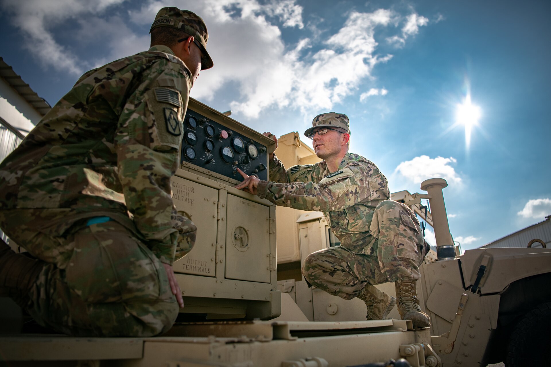 Sgt. James Whitlock, right, a multichannel transmission system operator-maintainer assigned to 75th Field Artillery Brigade, Fort Sill, OK, shows Spc. Marcus Jefferson, a multichannel transmission systems operator-maintainer, how to properly identify and troubleshoot problems on a generator while deployed to the Middle East in support of Operation Spartan Shield and Operation Inherent Resolve, December 18, 2020.