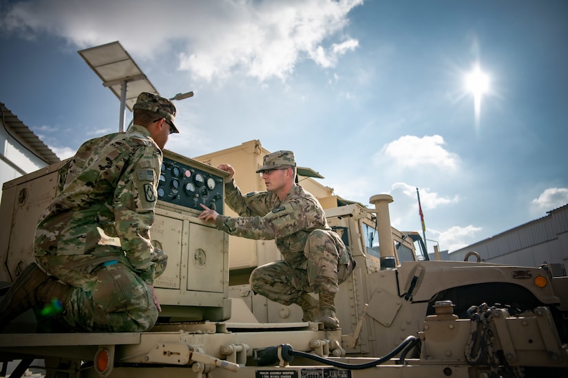Sgt. James Whitlock, right, a multichannel transmission system operator-maintainer assigned to 75th Field Artillery Brigade, Fort Sill, OK, shows Spc. Marcus Jefferson, a multichannel transmission systems operator-maintainer, how to properly identify and troubleshoot problems on a generator while deployed to the Middle East in support of Operation Spartan Shield and Operation Inherent Resolve, December 18, 2020.