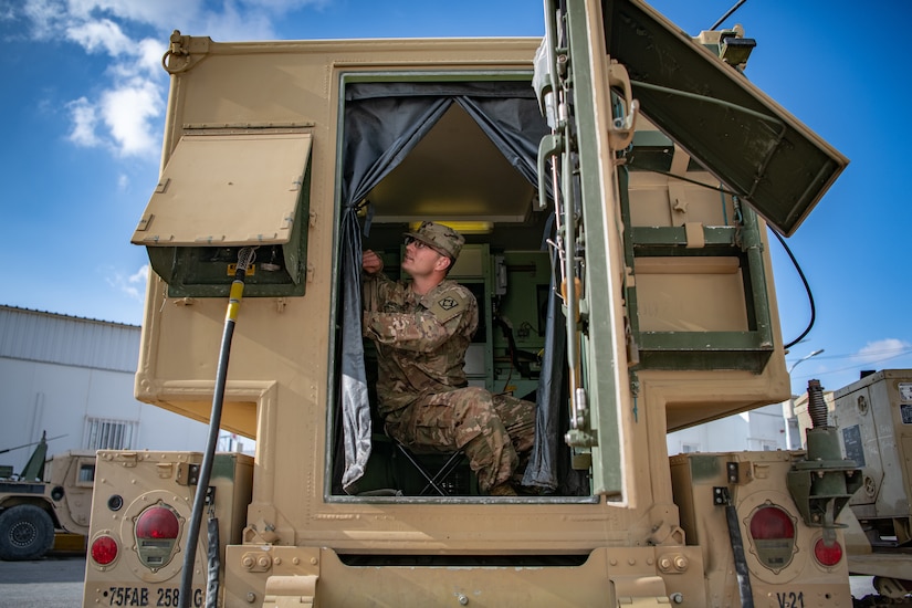 Sgt. James Whitlock, right, a multichannel transmission system operator-maintainer assigned to 75th Field Artillery Brigade, Fort Sill, OK, works on his assigned equipment while deployed to the Middle East in support of Operation Spartan Shield and Operation Inherent Resolve, December 18, 2020.