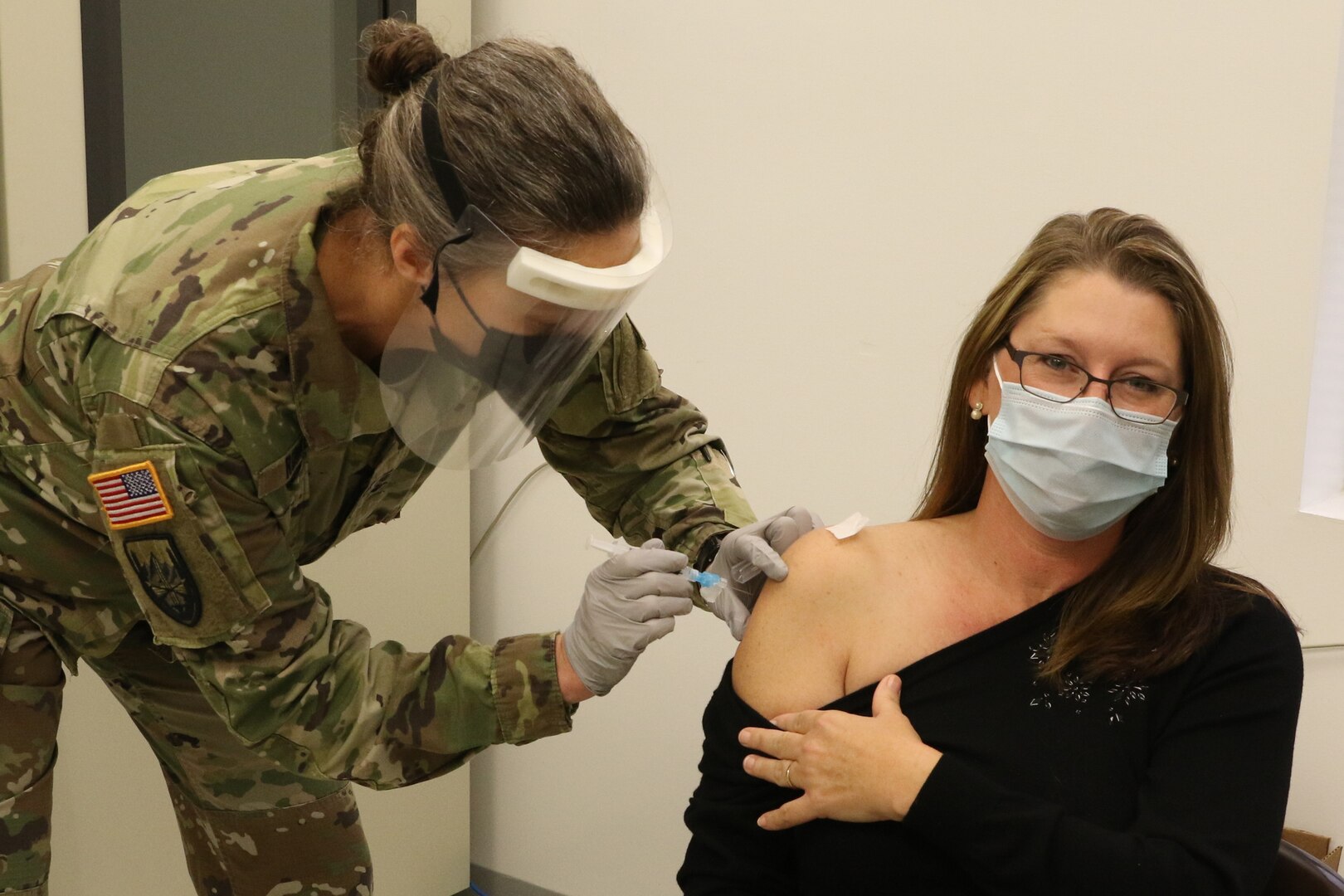 Bobbie Rae receives a COVID-19 vaccination from Col. Brenda Ruhrer Dec. 31, 2020, at Fort Pickett, Virginia.